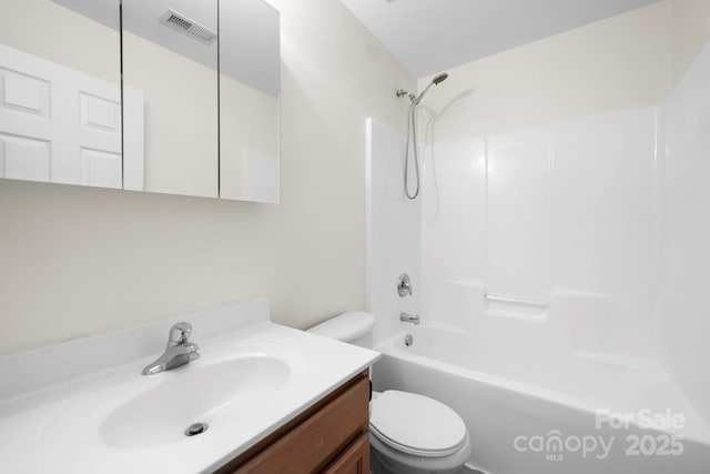 bathroom with visible vents, toilet, vanity, and  shower combination