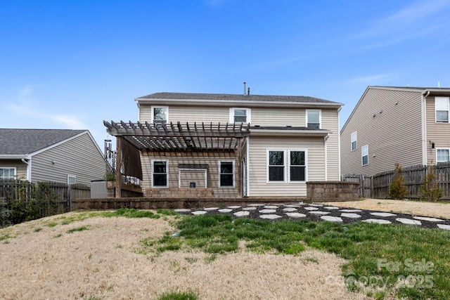 rear view of property featuring a fenced backyard and a pergola