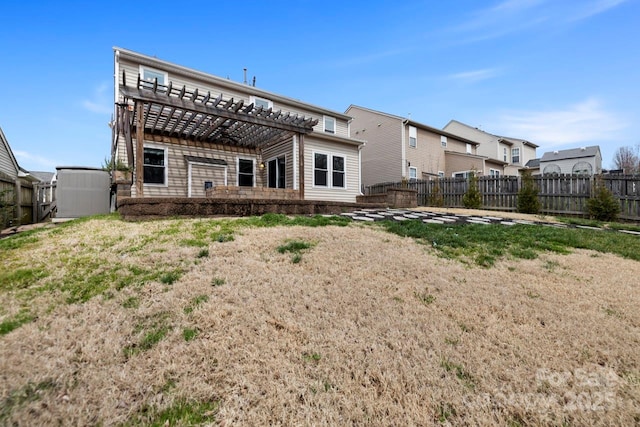 back of property with a pergola and a fenced backyard