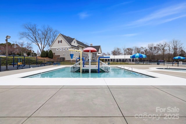 pool featuring a patio, fence, and playground community