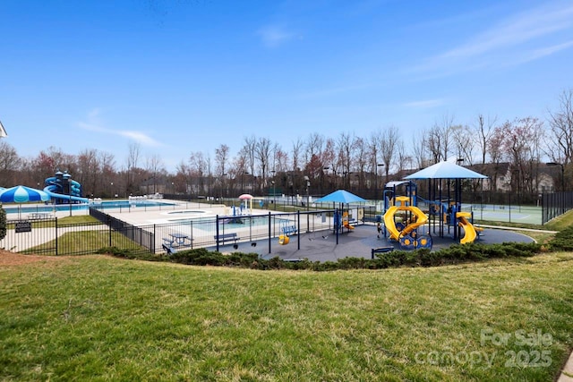 community play area with a yard, a community pool, and fence