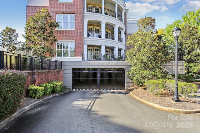 5425 Closeburn Rd Unit 309, Charlotte, NC 28210 - back of house featuring asphalt driveway, a garage, and brick siding