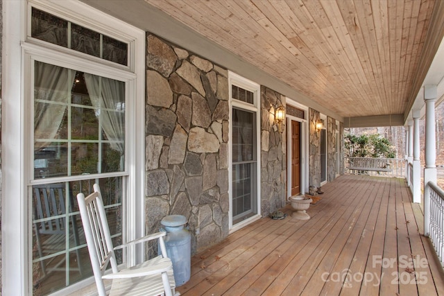 wooden terrace with a porch