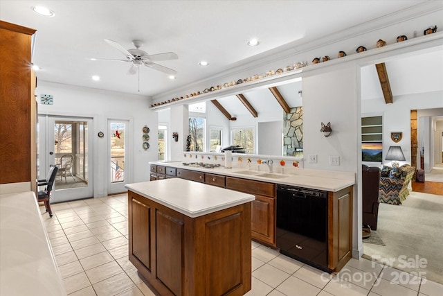 kitchen with a center island, dishwasher, light countertops, a ceiling fan, and a sink