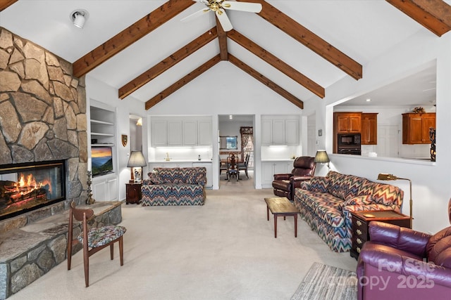 living room with ceiling fan, beamed ceiling, light carpet, a fireplace, and high vaulted ceiling