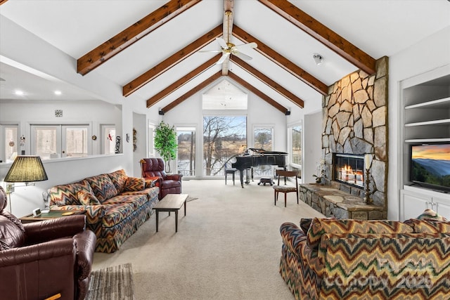 carpeted living area featuring ceiling fan, beamed ceiling, a fireplace, and high vaulted ceiling