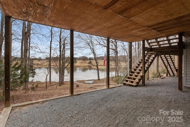 view of patio / terrace with stairs and a water view