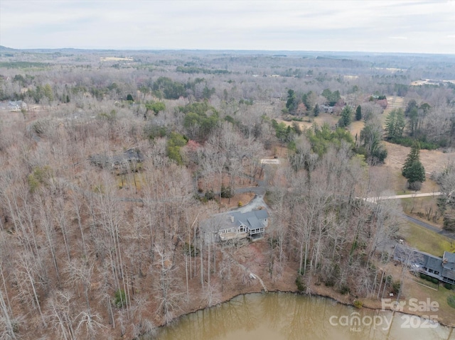 aerial view featuring a view of trees and a water view