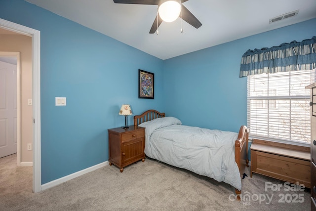 carpeted bedroom featuring visible vents, baseboards, and a ceiling fan
