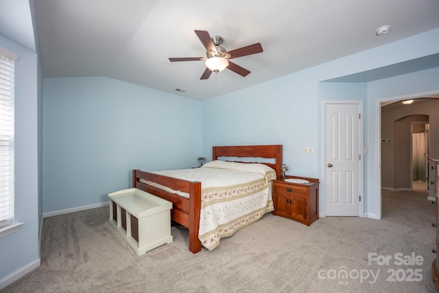 bedroom featuring visible vents, light carpet, arched walkways, baseboards, and vaulted ceiling