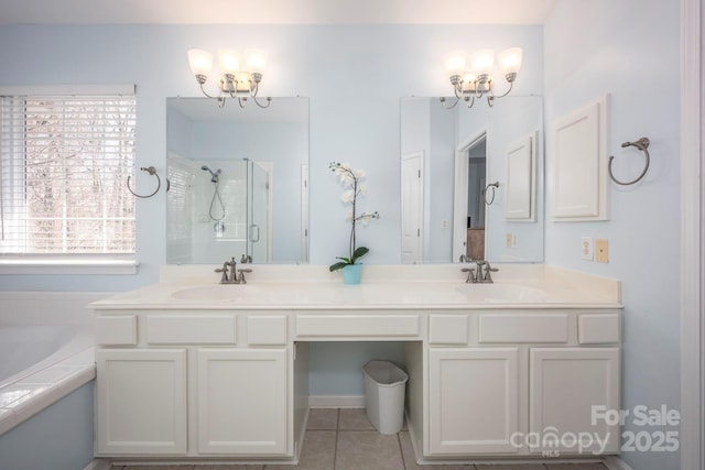 bathroom with tile patterned floors, a garden tub, a sink, a shower stall, and double vanity