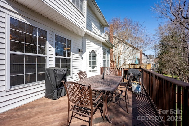 wooden terrace with outdoor dining space