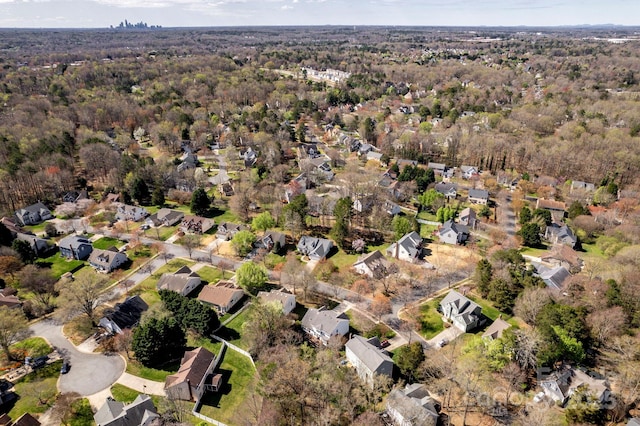 aerial view with a residential view and a view of trees
