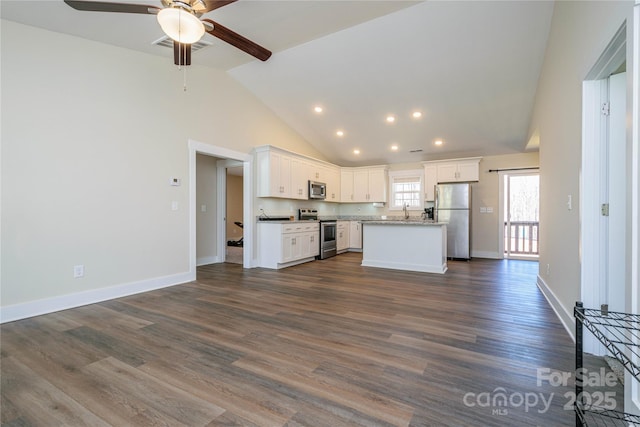 kitchen featuring white cabinetry, open floor plan, and appliances with stainless steel finishes