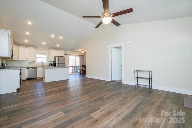 unfurnished living room featuring baseboards, vaulted ceiling, recessed lighting, a ceiling fan, and dark wood-style flooring