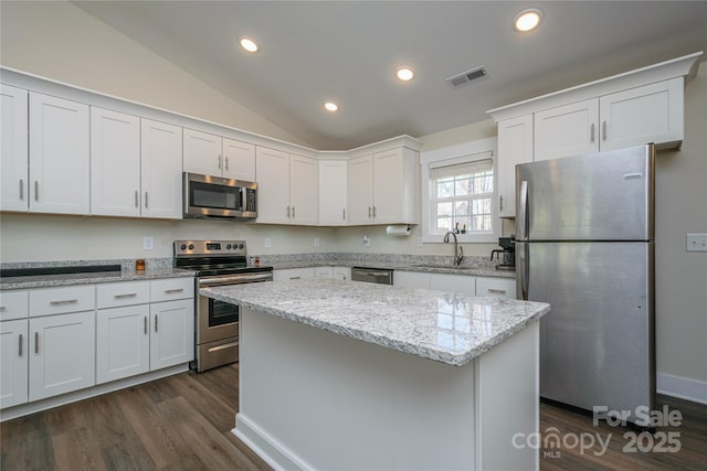 kitchen with visible vents, vaulted ceiling, recessed lighting, appliances with stainless steel finishes, and white cabinetry