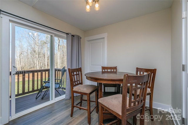 dining area featuring wood finished floors and baseboards