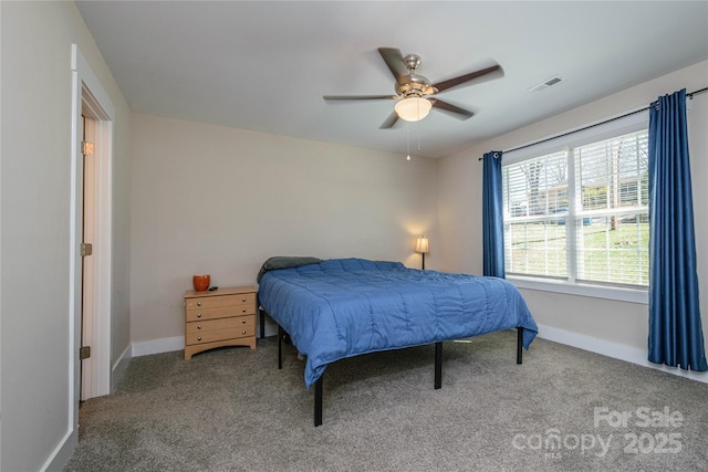 carpeted bedroom featuring visible vents, baseboards, and a ceiling fan