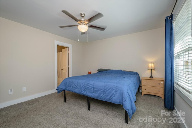 carpeted bedroom featuring ceiling fan and baseboards