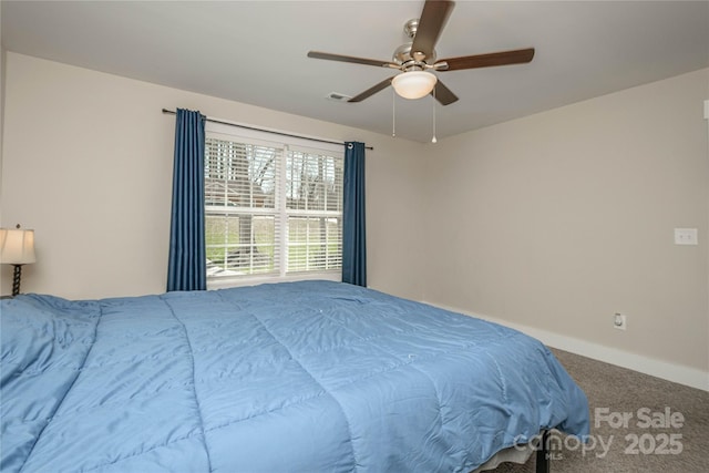 carpeted bedroom with visible vents, baseboards, and a ceiling fan