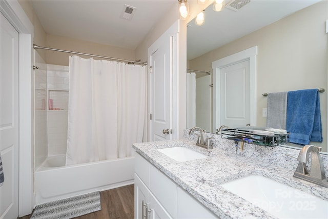 full bath with shower / bath combination with curtain, visible vents, and a sink