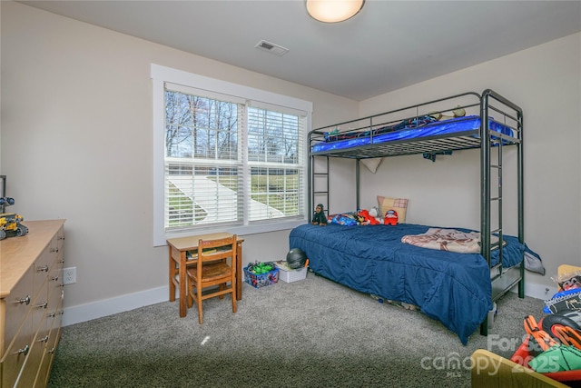 carpeted bedroom featuring baseboards and visible vents