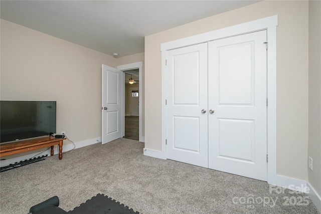 interior space with carpet and baseboards