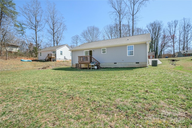 back of house featuring crawl space, central air condition unit, and a yard