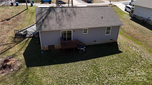 rear view of house with central air condition unit, a lawn, roof with shingles, and crawl space