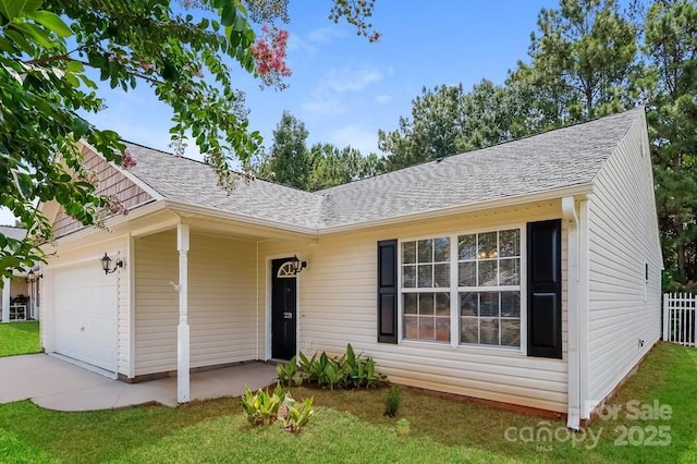 single story home featuring an attached garage and a shingled roof