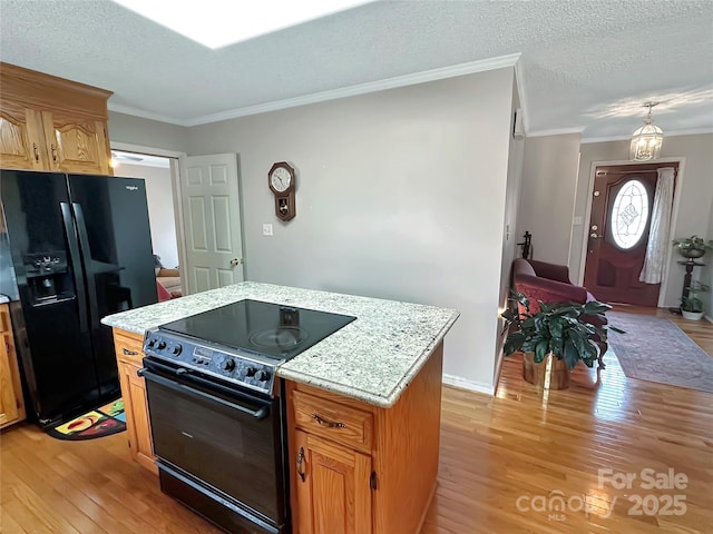 kitchen featuring light wood finished floors, black appliances, crown molding, light stone counters, and a textured ceiling