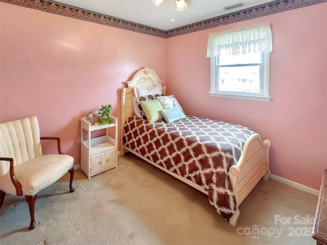 carpeted bedroom featuring visible vents and baseboards