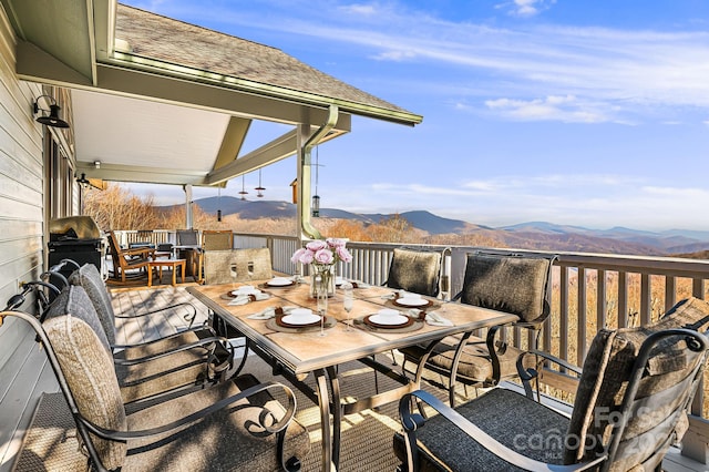 exterior space with a grill, a mountain view, and outdoor dining area