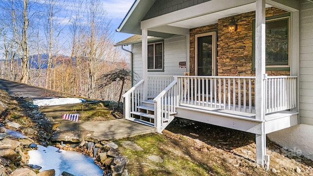 wooden terrace featuring covered porch