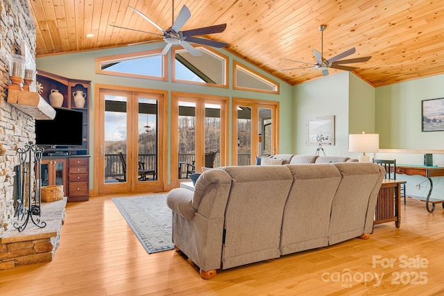 living area featuring hardwood / wood-style flooring, a ceiling fan, wooden ceiling, and high vaulted ceiling