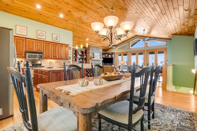 dining room with wooden ceiling, light wood-style flooring, high vaulted ceiling, and a chandelier