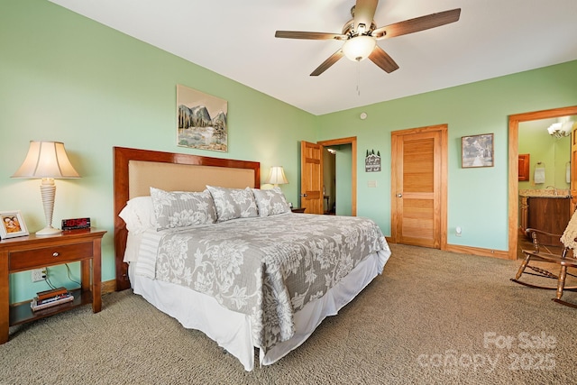 bedroom with ensuite bath, baseboards, carpet floors, and ceiling fan