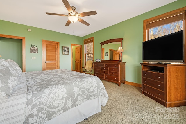 bedroom featuring baseboards, a ceiling fan, and carpet