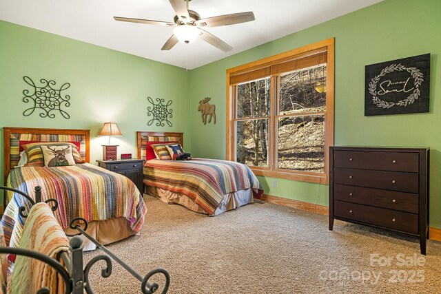 bedroom featuring a ceiling fan, carpet, and baseboards