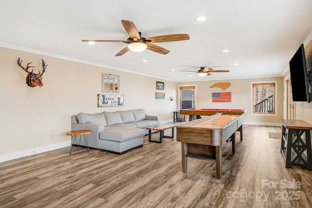 living room with recessed lighting, ornamental molding, baseboards, and wood finished floors