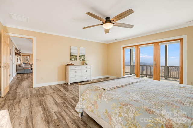 unfurnished bedroom featuring access to exterior, visible vents, baseboards, and wood finished floors