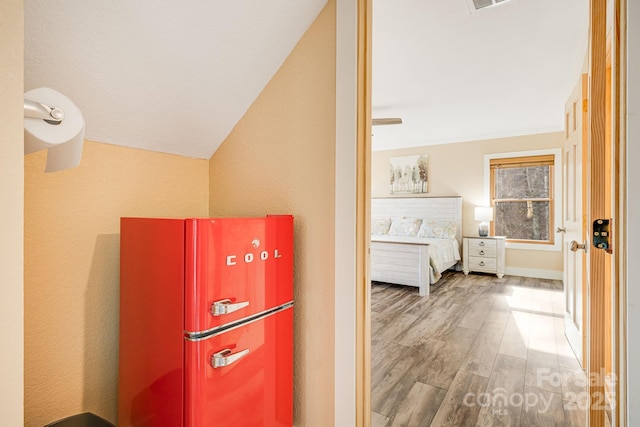 corridor with visible vents and wood finished floors