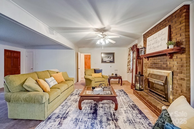 living area featuring a fireplace, a ceiling fan, and ornamental molding