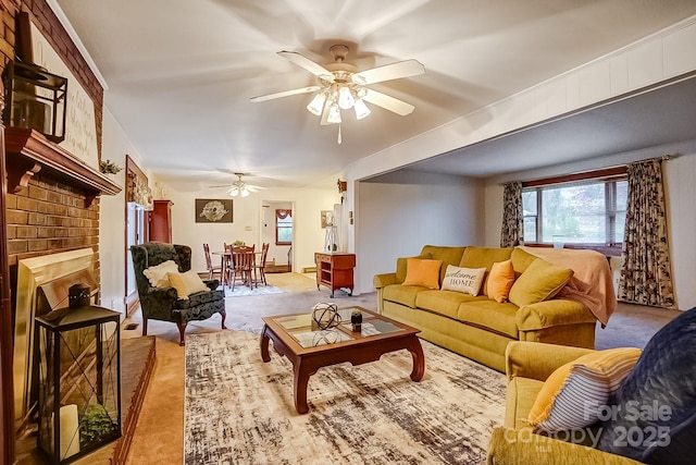 living room with a ceiling fan, carpet flooring, and a fireplace