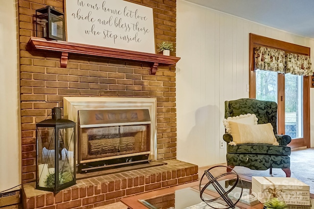 living area featuring a fireplace, carpet, and ornamental molding