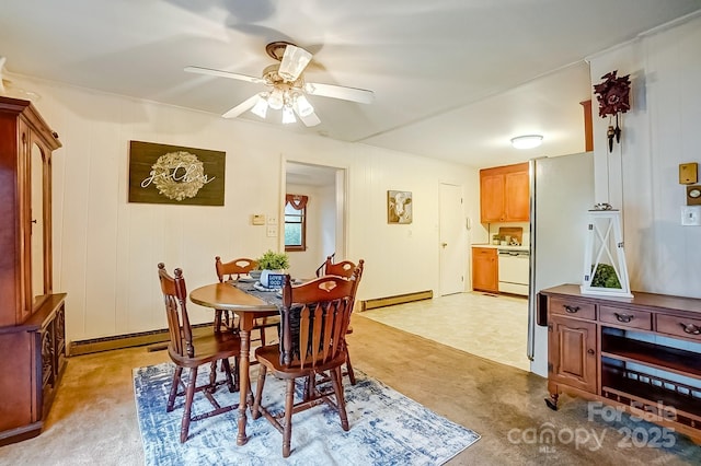 dining space with light carpet, baseboard heating, and ceiling fan