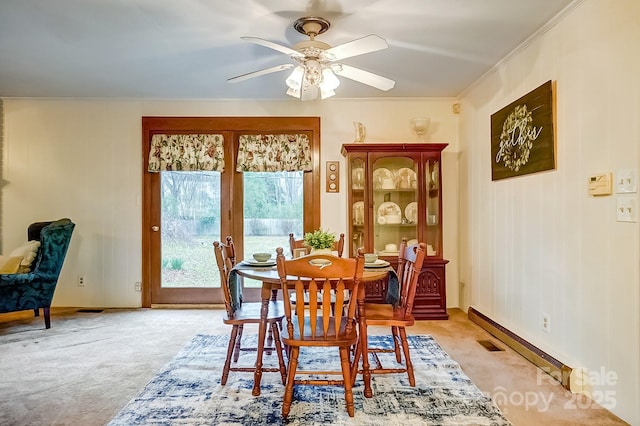 dining room featuring ceiling fan, light carpet, ornamental molding, and a baseboard radiator