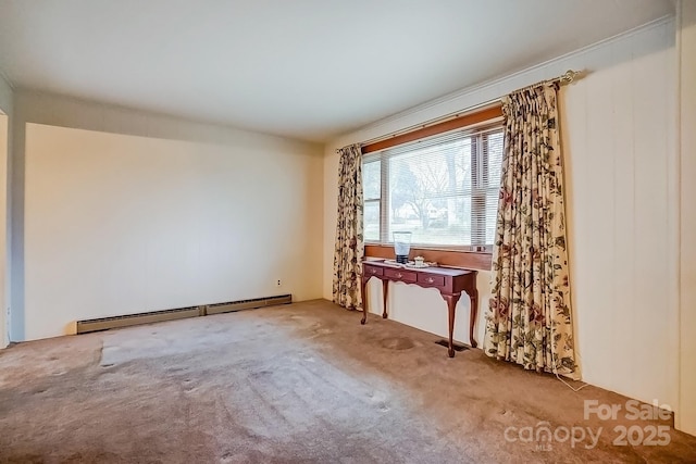 spare room featuring a baseboard radiator and carpet flooring