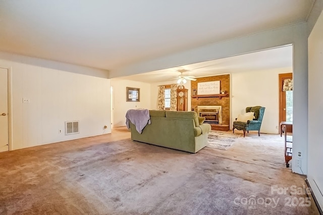 living area with ceiling fan, visible vents, a fireplace, and carpet flooring