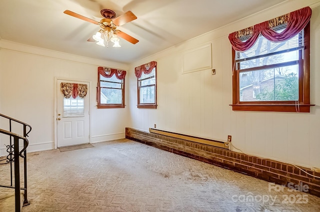 interior space featuring a baseboard heating unit, carpet floors, and a ceiling fan